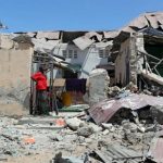 A Somali man looks at the damages caused by a car that exploded outside his home in the Madina district of Mogadishu