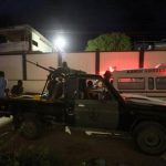 Armed security forces and rescue personnel are seen at the scene of an attack outside an hotel in Mogadishu